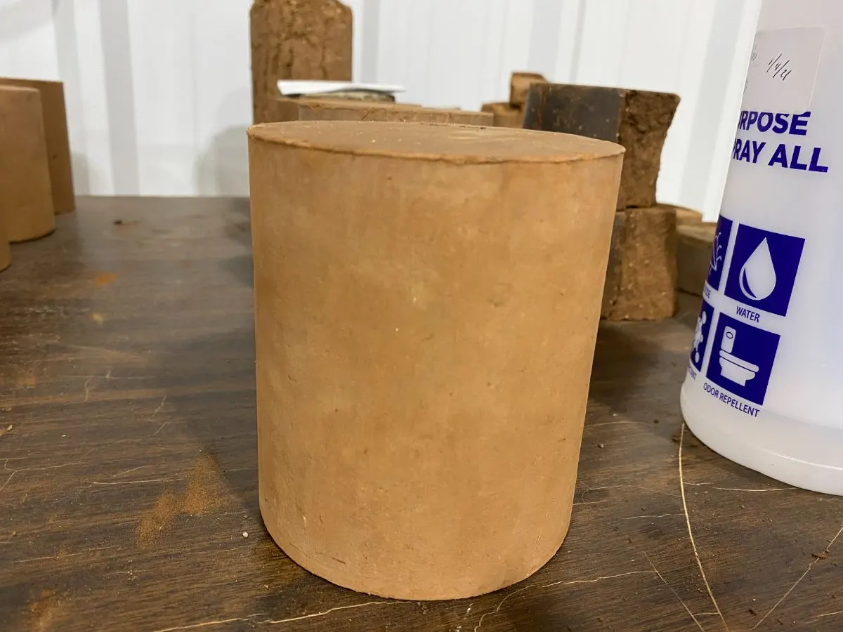 Cured soil cylinder treated with SoilPak-250 on a lab bench
